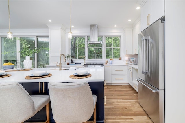480 Ackerly Pond Ln, Southold, NY 11971 - kitchen with appliances with stainless steel finishes, island range hood, a sink, light countertops, and white cabinetry