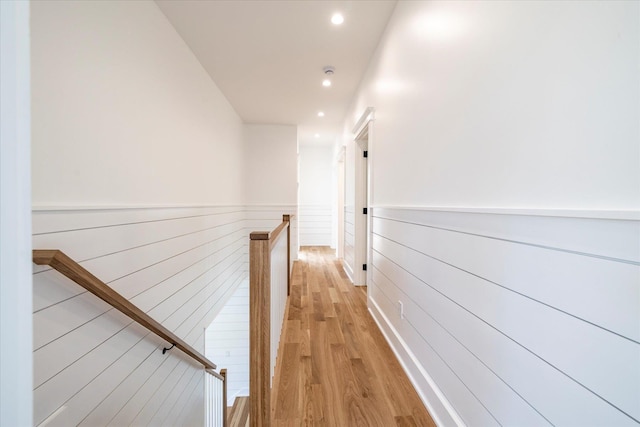 480 Ackerly Pond Ln, Southold, NY 11971 - hallway featuring an upstairs landing, recessed lighting, light wood-type flooring, and a wainscoted wall