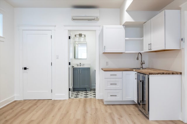 480 Ackerly Pond Ln, Southold, NY 11971 - kitchen featuring beverage cooler, wood counters, a wall mounted air conditioner, light wood-style flooring, and open shelves