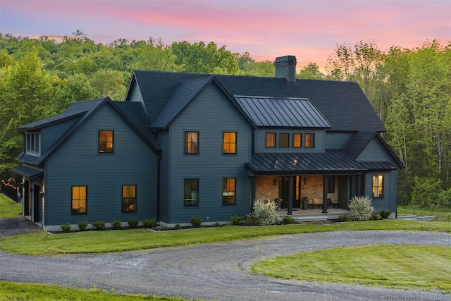 36 Spruce Ln, Poughkeepsie, NY 12603 - modern farmhouse style home with a standing seam roof, curved driveway, a porch, a chimney, and a front yard