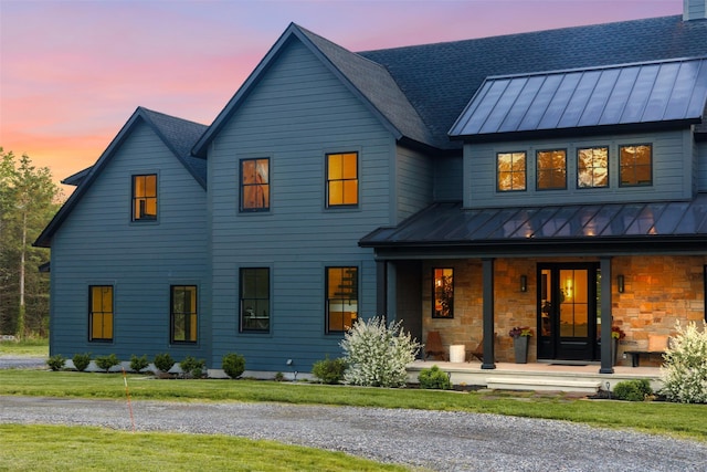 36 Spruce Ln, Poughkeepsie, NY 12603 - rear view of house featuring a standing seam roof, metal roof, covered porch, and a lawn