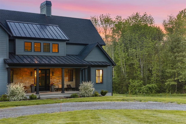 36 Spruce Ln, Poughkeepsie, NY 12603 - rear view of house featuring a standing seam roof, metal roof, a porch, a lawn, and roof with shingles
