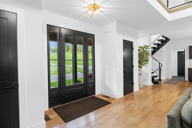 36 Spruce Ln, Poughkeepsie, NY 12603 - entryway with stairway, light wood-style flooring, baseboards, and a chandelier