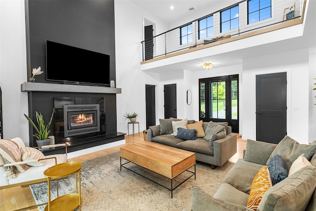 36 Spruce Ln, Poughkeepsie, NY 12603 - living area with a towering ceiling, a glass covered fireplace, and wood finished floors