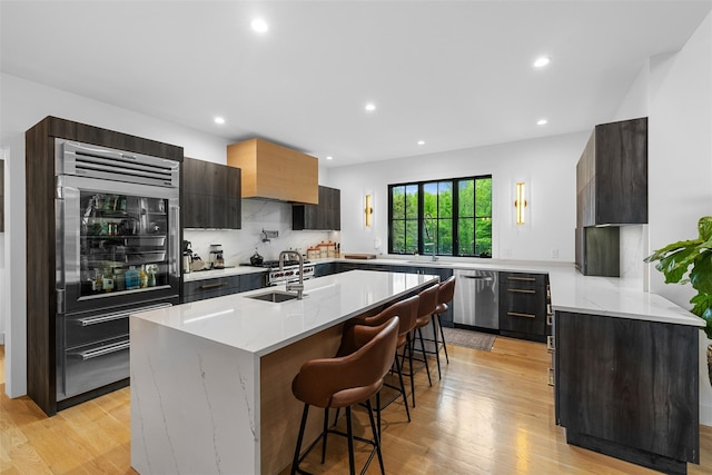 36 Spruce Ln, Poughkeepsie, NY 12603 - kitchen with built in fridge, dishwasher, light wood finished floors, recessed lighting, and a kitchen island with sink