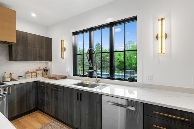 36 Spruce Ln, Poughkeepsie, NY 12603 - kitchen with dishwasher, a sink, modern cabinets, light wood-style flooring, and light stone counters
