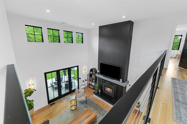36 Spruce Ln, Poughkeepsie, NY 12603 - living room with light wood finished floors, a glass covered fireplace, recessed lighting, and baseboards