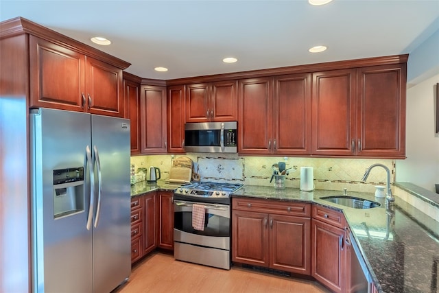 12 Whitman Ave, Bellmore, NY 11710 - kitchen with appliances with stainless steel finishes, a sink, dark stone counters, light wood-style floors, and recessed lighting