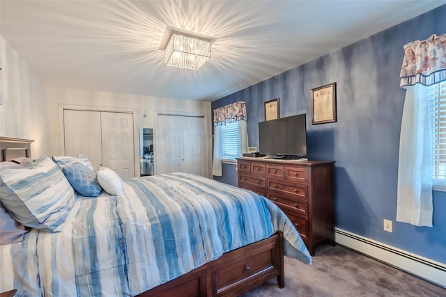 12 Whitman Ave, Bellmore, NY 11710 - bedroom with baseboard heating, two closets, dark carpet, a chandelier, and baseboards
