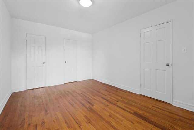 100-11 67th Rd Unit 416, Forest Hills, NY 11375 - unfurnished bedroom featuring wood finished floors and baseboards