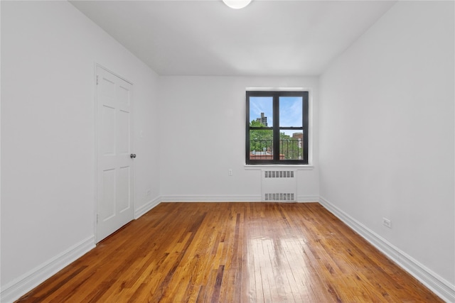 100-11 67th Rd Unit 416, Forest Hills, NY 11375 - spare room with radiator heating unit, hardwood / wood-style flooring, and baseboards