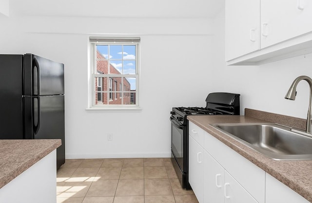 210 Pelham Rd Unit 6H, New Rochelle, NY 10805 - kitchen with black appliances, a sink, white cabinets, baseboards, and light tile patterned flooring