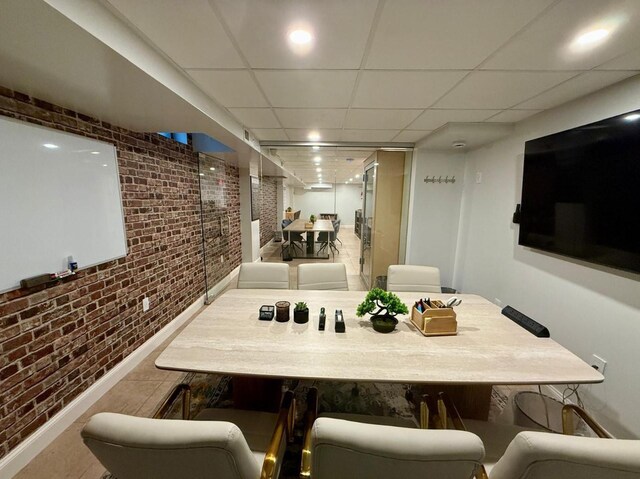 210 Pelham Rd Unit 6H, New Rochelle, NY 10805 - dining room with brick wall, a paneled ceiling, and baseboards