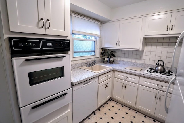 35 Bon Aire Cir Unit 8113, Suffern, NY 10901 - kitchen with white appliances, a sink, white cabinetry, light countertops, and backsplash