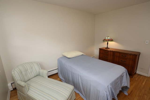 35 Bon Aire Cir Unit 8113, Suffern, NY 10901 - bedroom featuring a baseboard heating unit, light wood-style flooring, and baseboards