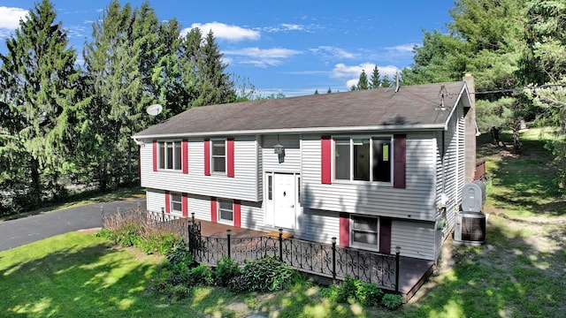 232 County Route 49, Slate Hill, NY 10973 - split foyer home with a front yard, a wooden deck, a chimney, and a shingled roof