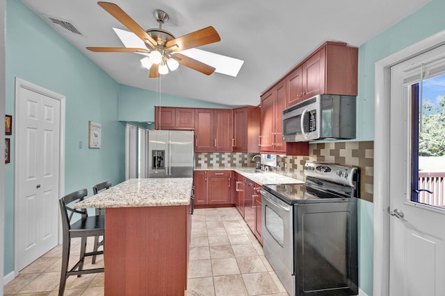 232 County Route 49, Slate Hill, NY 10973 - kitchen with stainless steel appliances, tasteful backsplash, a center island, a ceiling fan, and a skylight