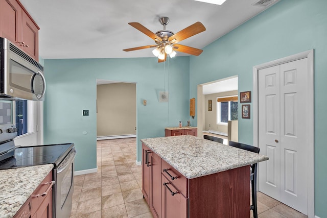 232 County Route 49, Slate Hill, NY 10973 - kitchen featuring stainless steel appliances, vaulted ceiling, a baseboard heating unit, ceiling fan, and a center island
