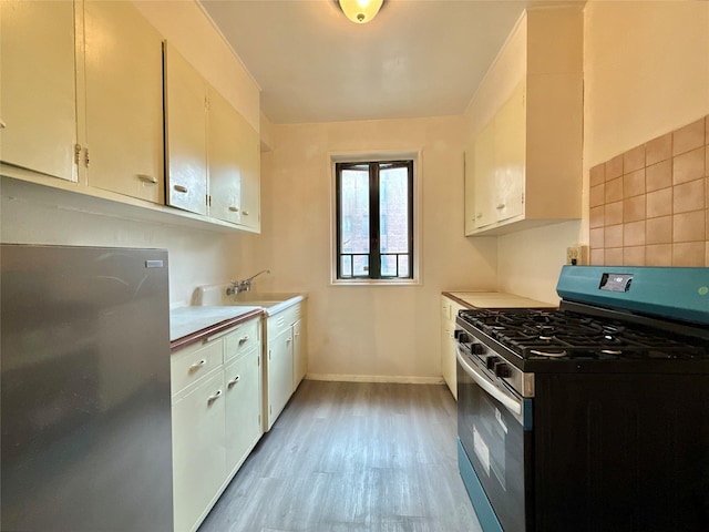 1522 Unionport Rd Unit 6C, Bronx, NY 10462 - kitchen with stainless steel appliances, light wood-type flooring, light countertops, and baseboards