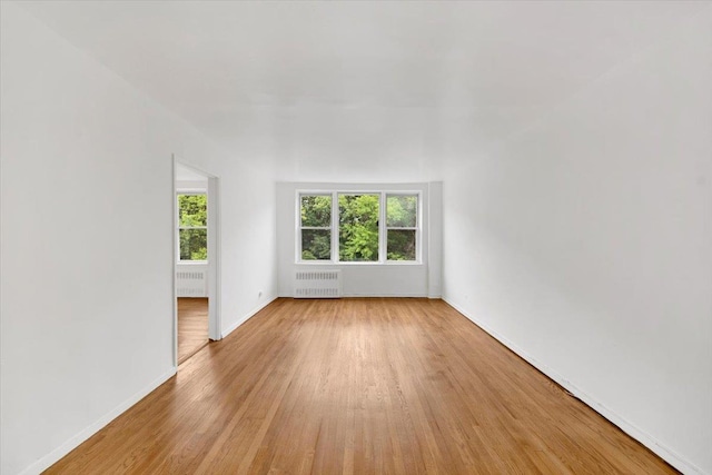 4320 E Van Cortlandt Park E Unit 5E, Bronx, NY 10470 - empty room featuring radiator and light wood finished floors