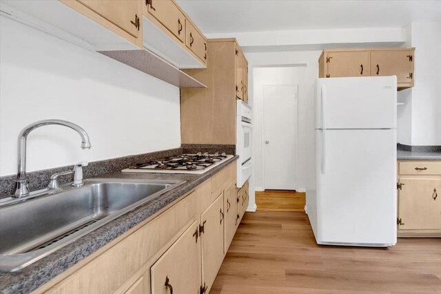 4320 E Van Cortlandt Park E Unit 5E, Bronx, NY 10470 - kitchen with white appliances, a sink, dark countertops, light wood-type flooring, and light brown cabinetry