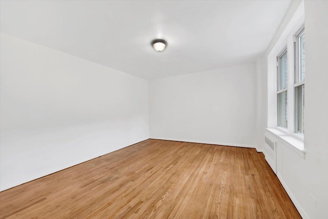 4320 E Van Cortlandt Park E Unit 5E, Bronx, NY 10470 - unfurnished room with radiator heating unit and light wood-style floors