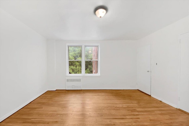 4320 E Van Cortlandt Park E Unit 5E, Bronx, NY 10470 - spare room featuring radiator and light wood-style flooring