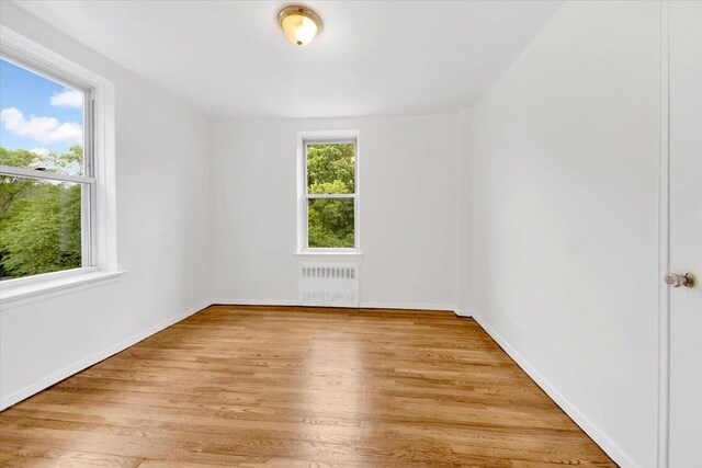 4320 E Van Cortlandt Park E Unit 5E, Bronx, NY 10470 - empty room with radiator and light wood-style floors
