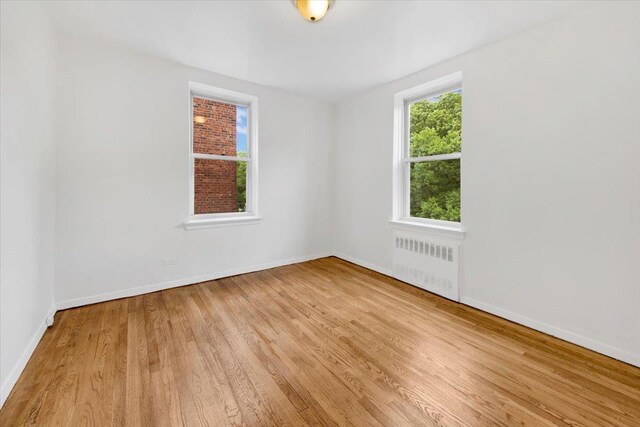 4320 E Van Cortlandt Park E Unit 5E, Bronx, NY 10470 - empty room featuring radiator heating unit, wood finished floors, and baseboards