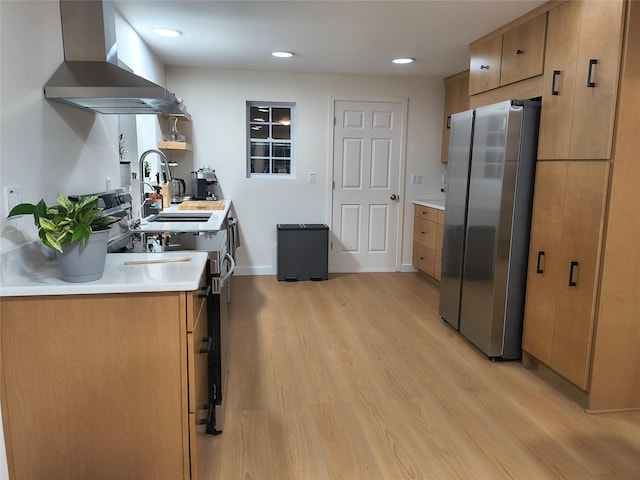 7 Fayer Ct, Phillipsport, NY 12769 - kitchen featuring stainless steel appliances, wall chimney range hood, a sink, light wood-type flooring, and light countertops