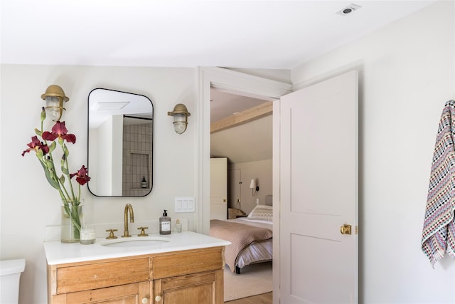 350 Skunk Ln, Cutchogue, NY 11935 - ensuite bathroom featuring vanity, lofted ceiling, and wood finished floors