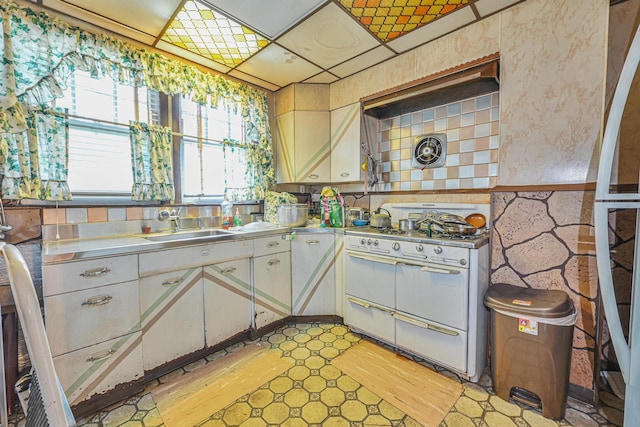 139-01 Linden Blvd, South Ozone Park, NY 11436 - kitchen featuring stainless steel countertops, double oven range, a sink, and white cabinetry