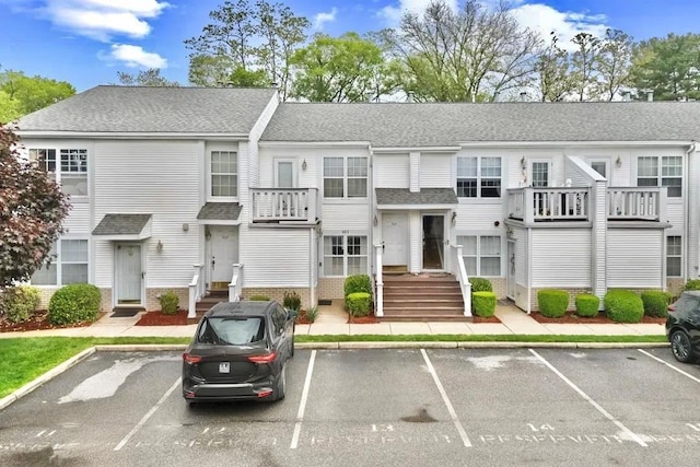 355 Old Tarrytown Rd Unit 603, White Plains, NY 10603 - view of front facade with uncovered parking, a shingled roof, and brick siding