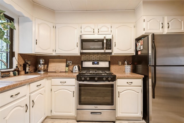 25 Cliffside Dr, Yonkers, NY 10710 - kitchen with stainless steel appliances, decorative backsplash, and light countertops