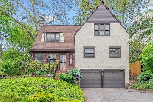 25 Cliffside Dr, Yonkers, NY 10710 - view of front facade with a garage, a chimney, asphalt driveway, and stucco siding
