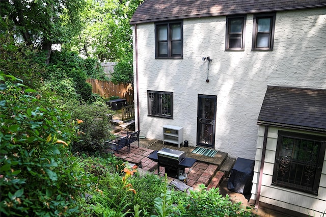 25 Cliffside Dr, Yonkers, NY 10710 - back of property featuring stucco siding, a shingled roof, and a patio
