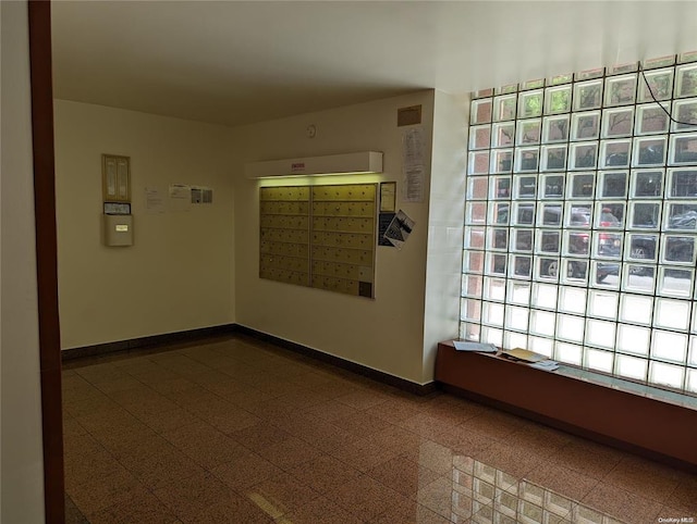 94-31 59th Ave Unit 4B, Elmhurst, NY 11373 - empty room with baseboards, mail area, and granite floors