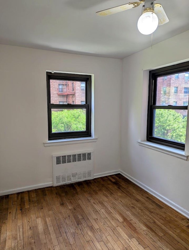 94-31 59th Ave Unit 4B, Elmhurst, NY 11373 - unfurnished room featuring radiator heating unit, hardwood / wood-style flooring, baseboards, and ceiling fan