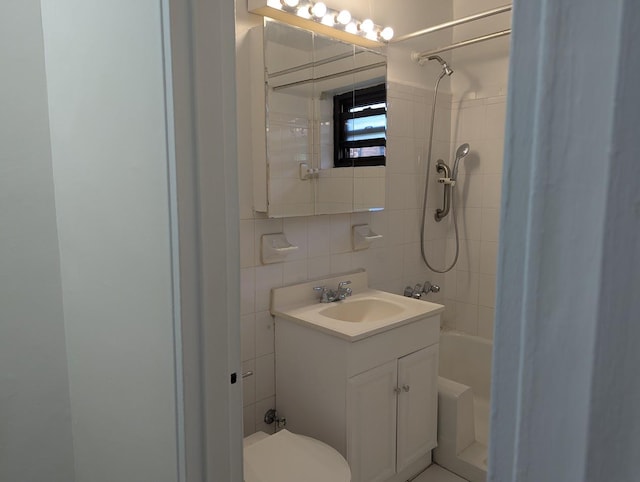 94-31 59th Ave Unit 4B, Elmhurst, NY 11373 - full bath with tile walls, vanity, toilet, and tasteful backsplash
