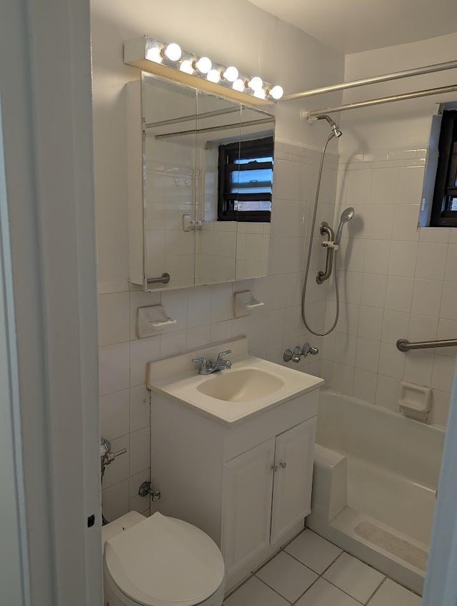 94-31 59th Ave Unit 4B, Elmhurst, NY 11373 - full bath featuring tile walls, vanity, toilet, tile patterned floors, and shower / washtub combination