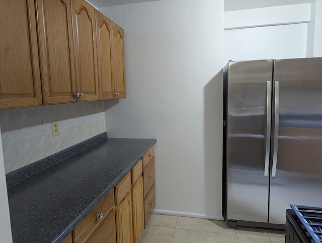94-31 59th Ave Unit 4B, Elmhurst, NY 11373 - kitchen with freestanding refrigerator, backsplash, brown cabinetry, and light tile patterned flooring