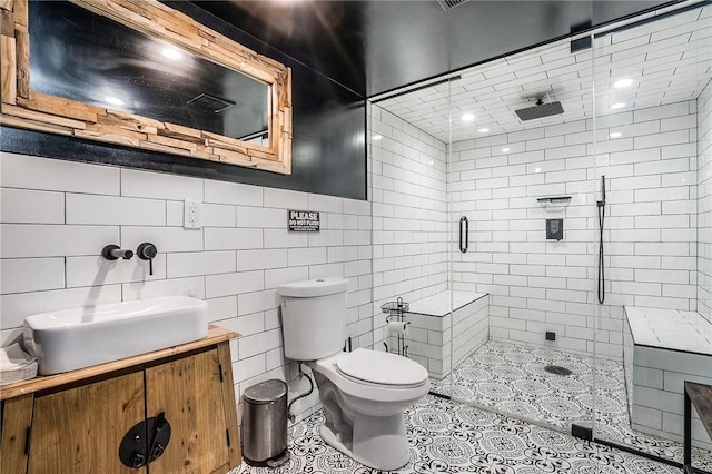 397 N Broadway Unit 3E, Yonkers, NY 10701 - full bathroom featuring a stall shower, toilet, vanity, tile walls, and tile patterned floors