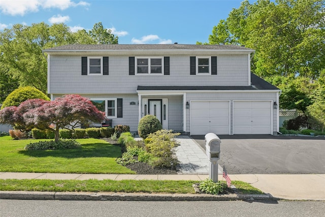 26 Wilson St, Port Jefferson Station, NY 11776 - view of front of house with driveway, a front yard, and a garage