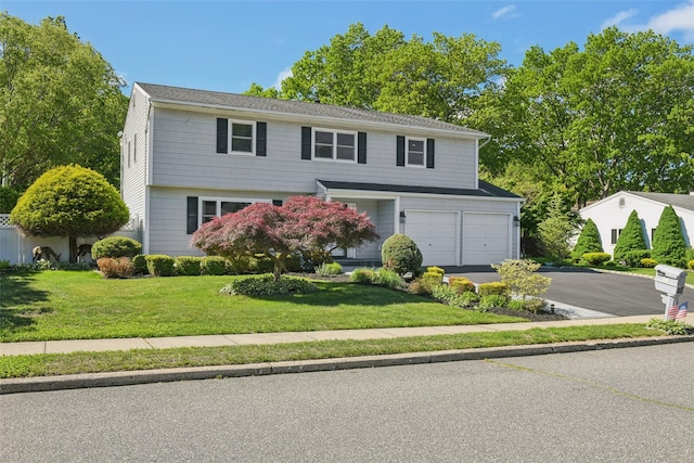 26 Wilson St, Port Jefferson Station, NY 11776 - view of front facade with driveway, a front lawn, and a garage