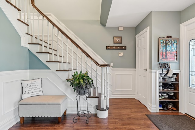 26 Wilson St, Port Jefferson Station, NY 11776 - foyer entrance featuring a decorative wall, stairway, wood finished floors, and a wainscoted wall