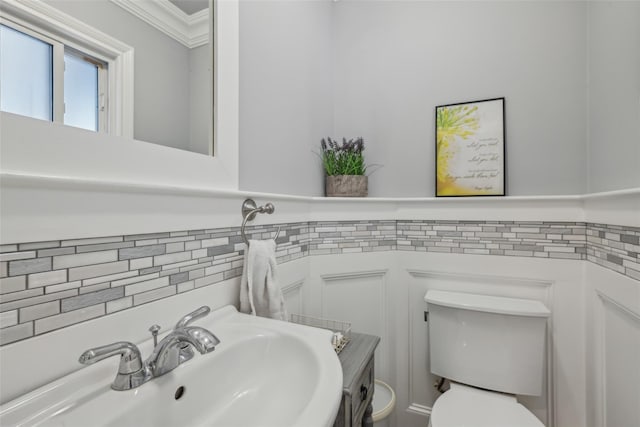 26 Wilson St, Port Jefferson Station, NY 11776 - bathroom featuring toilet, a sink, ornamental molding, and tasteful backsplash
