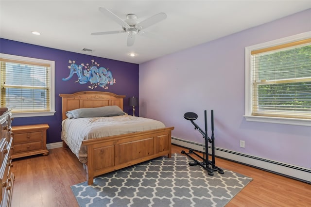 26 Wilson St, Port Jefferson Station, NY 11776 - bedroom with multiple windows, wood finished floors, baseboard heating, and recessed lighting