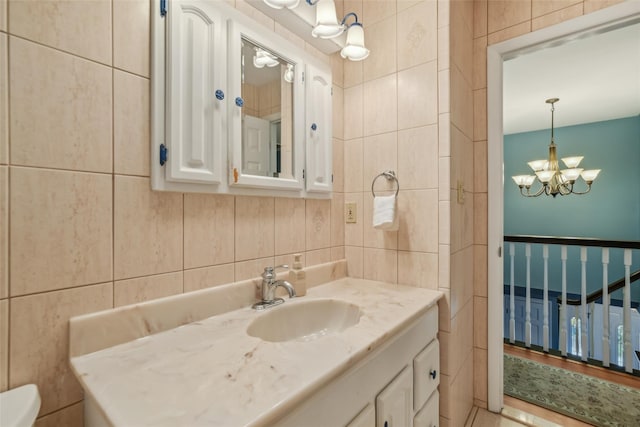 26 Wilson St, Port Jefferson Station, NY 11776 - half bath featuring tile walls, vanity, a chandelier, and toilet