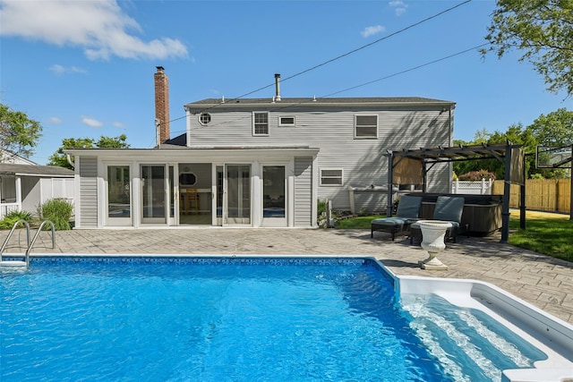 26 Wilson St, Port Jefferson Station, NY 11776 - back of house featuring a pergola, a patio area, a chimney, and a hot tub