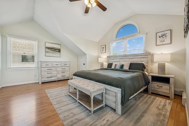 2660 Rosebud Ave, Merrick, NY 11566 - bedroom featuring lofted ceiling, multiple windows, wood finished floors, a ceiling fan, and baseboards